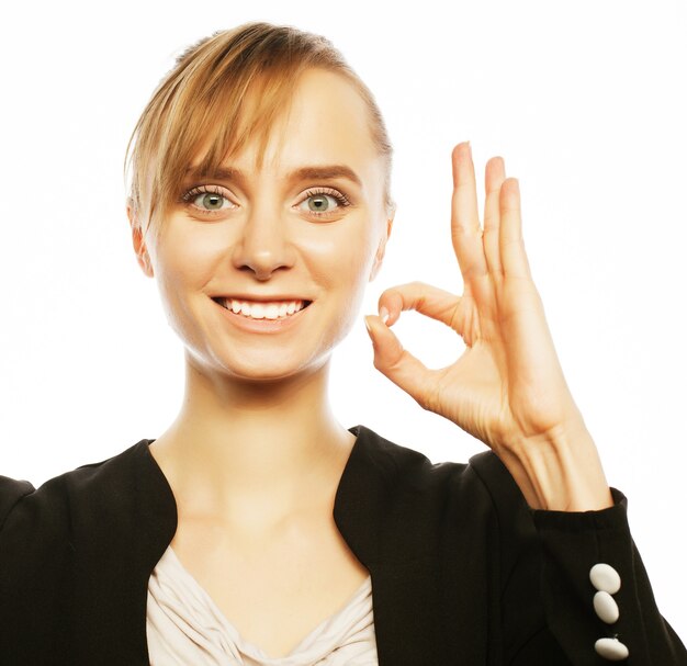 Happy smiling cheerful young business woman with okay gesture, over white background