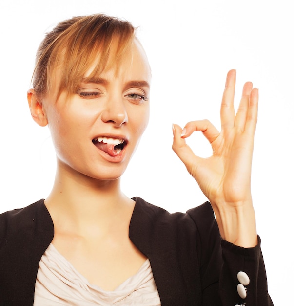 Happy smiling cheerful young business woman with okay gesture over white background