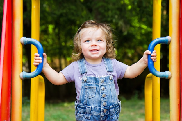 Happy smiling child  playing in a  playground area 