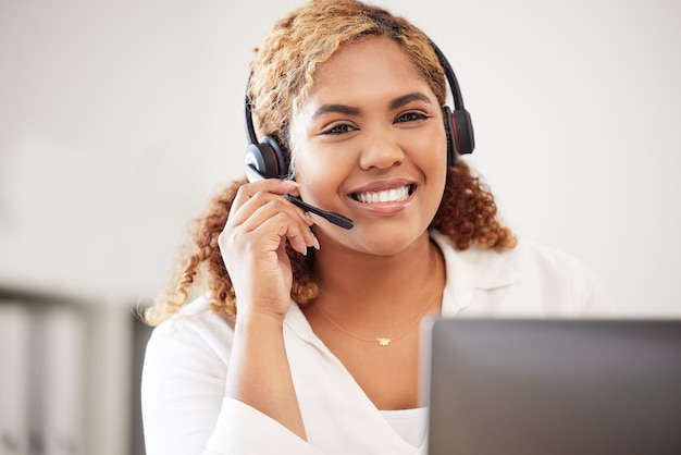 Happy smiling and friendly call center agent wearing headset while working in an office Portrait of confident businesswoman consulting and operating helpdesk for customer sales and service support