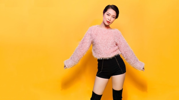 Happy Smiling Hipster Girl in knitted pink sweater having fun