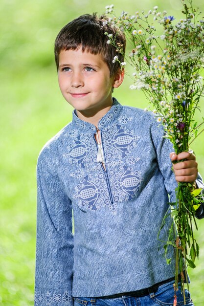 Happy smiling little boy dressed in national ukrainian style dress.