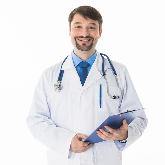 Happy smiling male doctor standing with folder, isolated on white wall