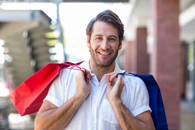  A happy smiling man with shopping bags