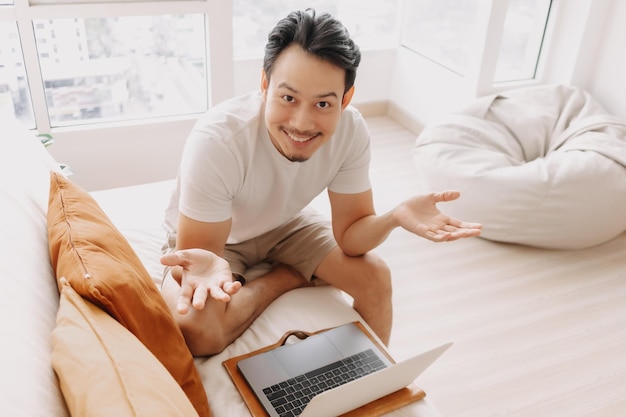 Happy smiling man working in his apartment in concept work from home