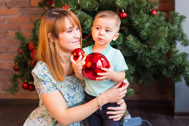 Happy Smiling Mother and Child at Home Celebrating Christmas