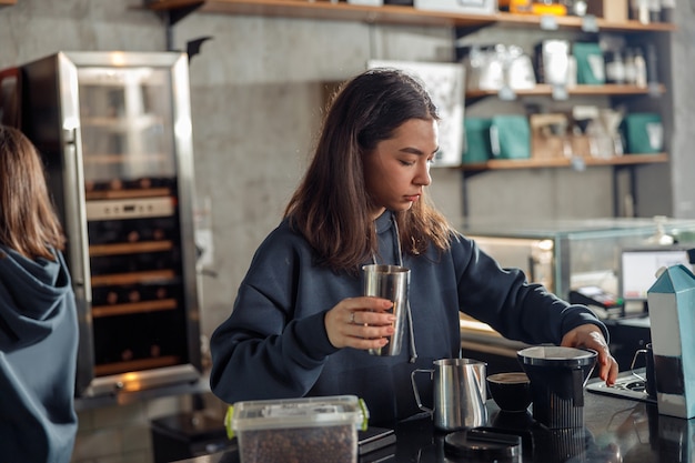 Happy smiling professional barista in cafe