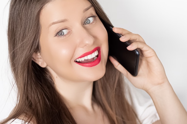 Happy smiling woman calling on smartphone portrait on white background people technology and communication concept