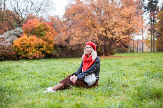 Happy smiling woman holding in her hands yellow maple leaves