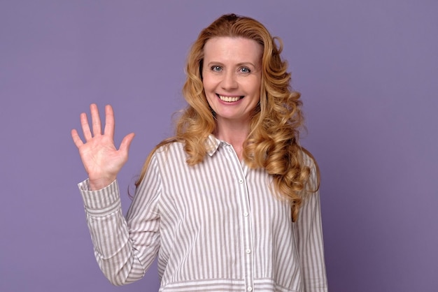 Happy smiling woman showing five fingers or hello hi gesture