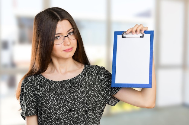 Happy smiling young beautiful business woman with clipboard