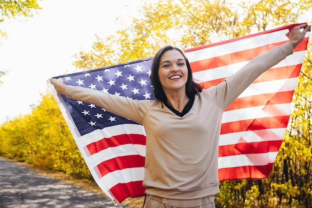 Happy smiling young woman with american flag