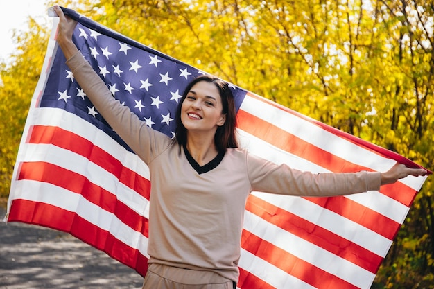 Happy smiling young woman with american flag