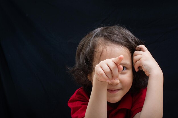 Happy smilinglittle kid boy pointing finger