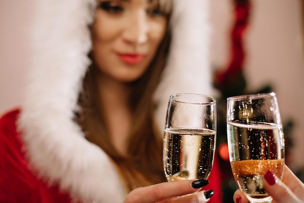 Happy Snow Maiden with glass of champagne isolated on white