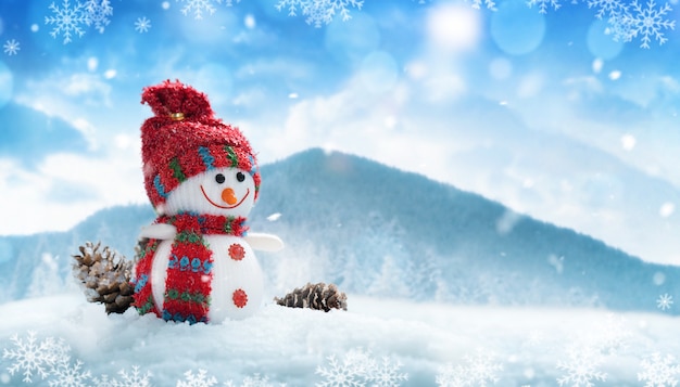 Happy snowman in red hat and scarf in winter scenery