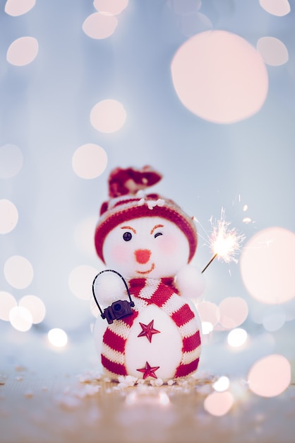 Happy snowman with a firework and bokeh. High quality photo