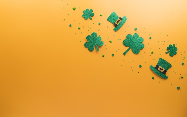 Happy St Patrick's Day decoration concept made from shamrocks clover leaf wooden calendar and leprechaun hat on yellow background