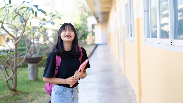 Happy student young girl with backpack at school.