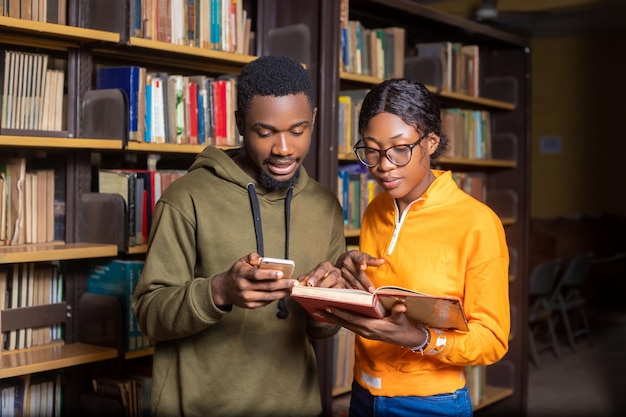 Happy students couple in school studying for exams together