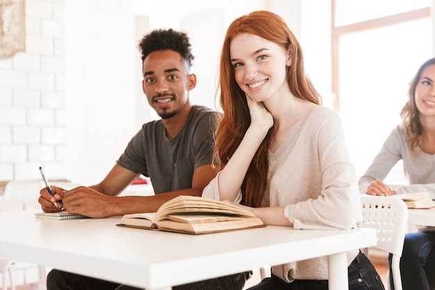 Happy students sitting in classroom