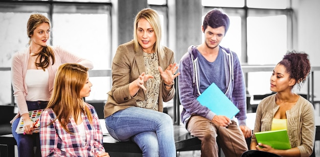 Happy students talking with their teacher