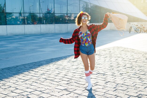 Happy stylish teenage girl with backpack