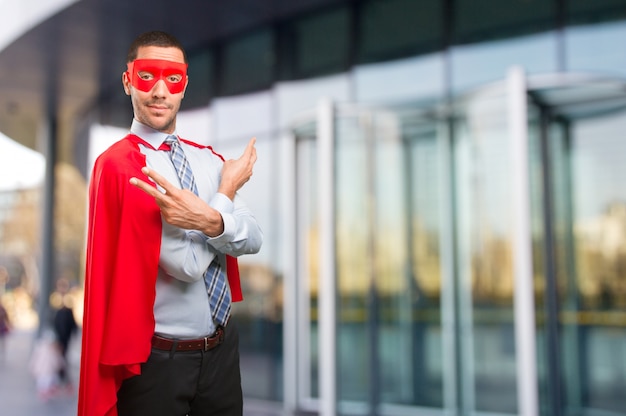 Happy super businessman doing a victory gesture