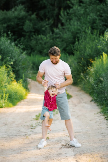 Happy and sweet moments of dad and son playing in the park in summer