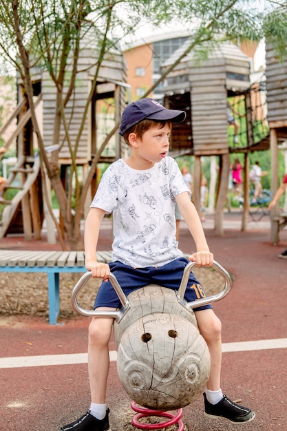 Happy swinging mouse on the playground. The boy in the playground, Riding a swing