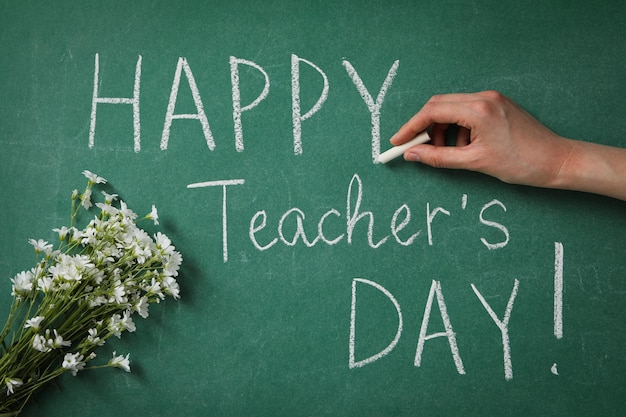 Happy teacher's day greetings inscription on a green board