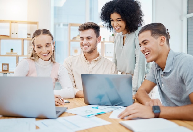 Happy team collaboration and teamwork by business people watching a laptop and waiting for results or feedback Diverse group online project with web developers trying new cad technology in an office