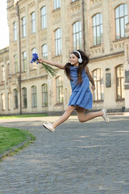 Happy teen girl in headphones girl run outdoor carefree girl running feel happiness