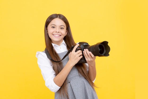 Happy teen girl photographer use digital photo camera, photographing.