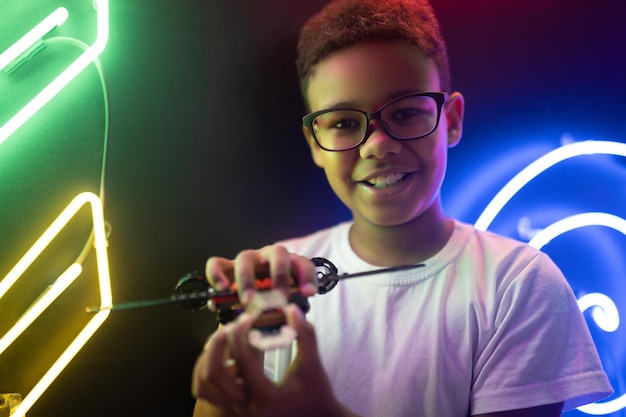 Happy teenage boy holding a toy chopper in his hands