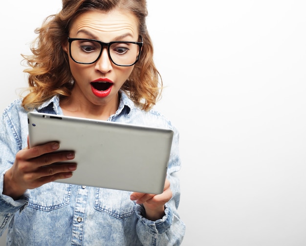 happy teenage girl wearing glasses with tablet pc computer