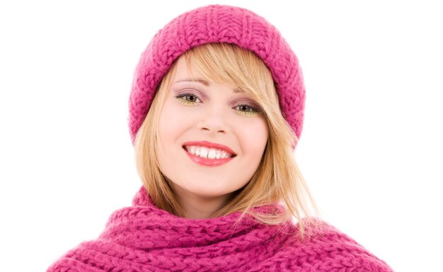 happy teenage girl in winter hat over white