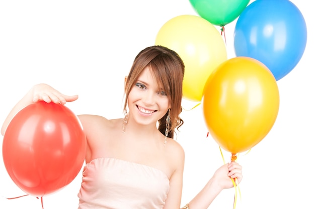 happy teenage girl with balloons over white