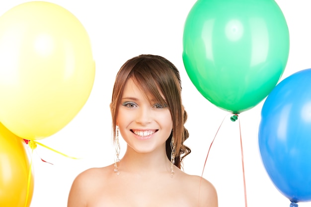 happy teenage girl with balloons over white