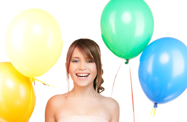 happy teenage girl with balloons over white