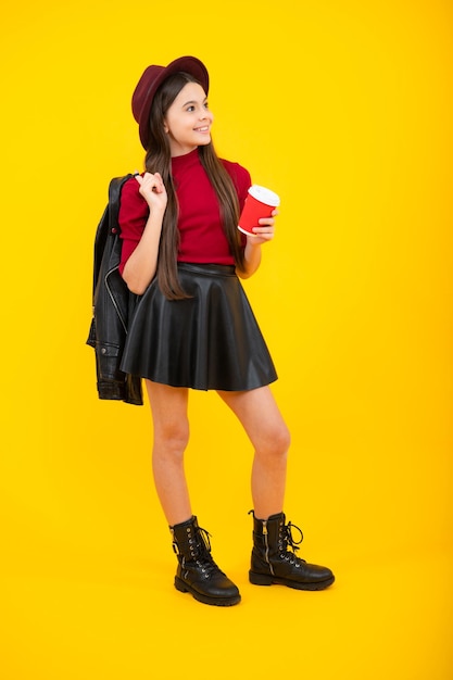 Happy teenager portrait Teenager girl holding a hot cup of coffee or tea Child with takeaway cup on