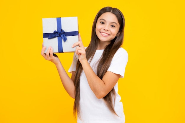 Happy teenager portrait Teenager kid with present box Teen girl giving birthday gift Present greeting and gifting concept Smiling girl