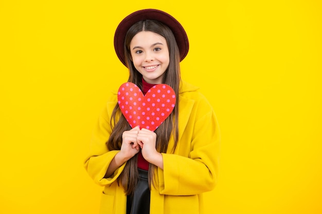 Happy teenager portrait Valentines Day Dreaming cute teen child with red heart Smiling girl