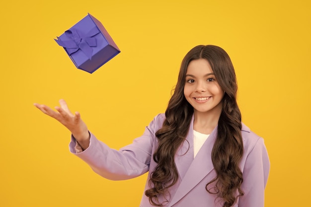 Happy teenager positive and smiling emotions of teen girl Child 1214 years old with gift on isolated background Birthday holiday concept Teenager hold present box