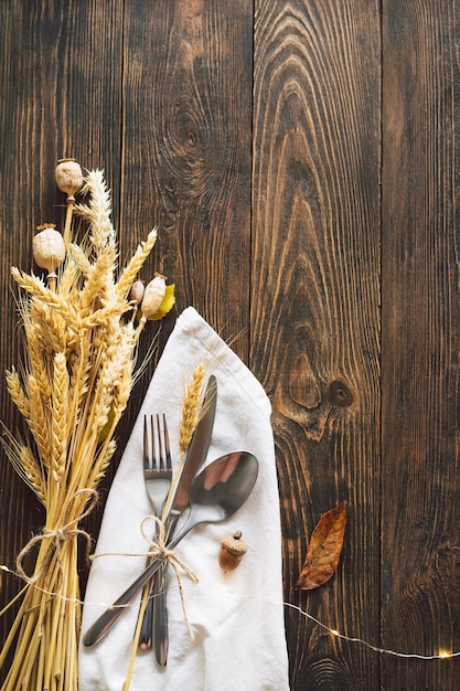 Happy Thanksgiving Autumn composition with leaves ripe pumpkin and Thanksgiving turkey on a dark wooden table Top view