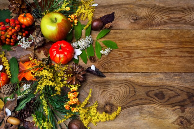 Happy Thanksgiving decor with rowan berries on wooden 