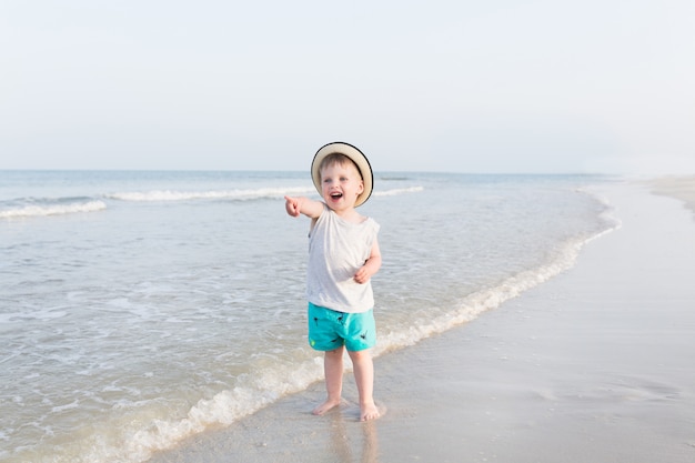 Happy three years old child boy in yellow hat