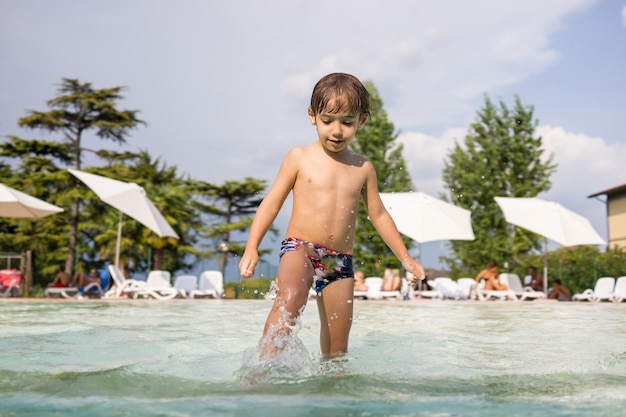 Happy time for kids of fun and enjoyment on summer swimming pool