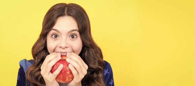 Happy toothy child girl bite fresh apple in cozy bathrobe childrens stomatology Child girl portrait with apple horizontal poster Banner header with copy space