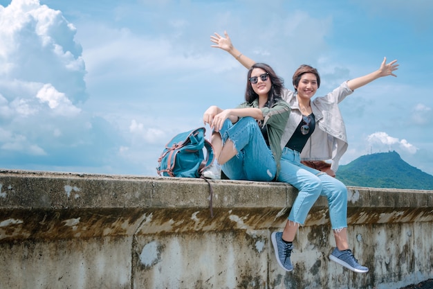 Happy tourist Asian couple relaxing together on vacation trip.